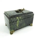 A nephrite stone jewellery box, rectangular form, on ogee bracket feet, hinged lid decorated with gi