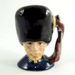 A Royal Doulton miniature character jug, Guardsman, blue lapel, silver and gold highlights colourway