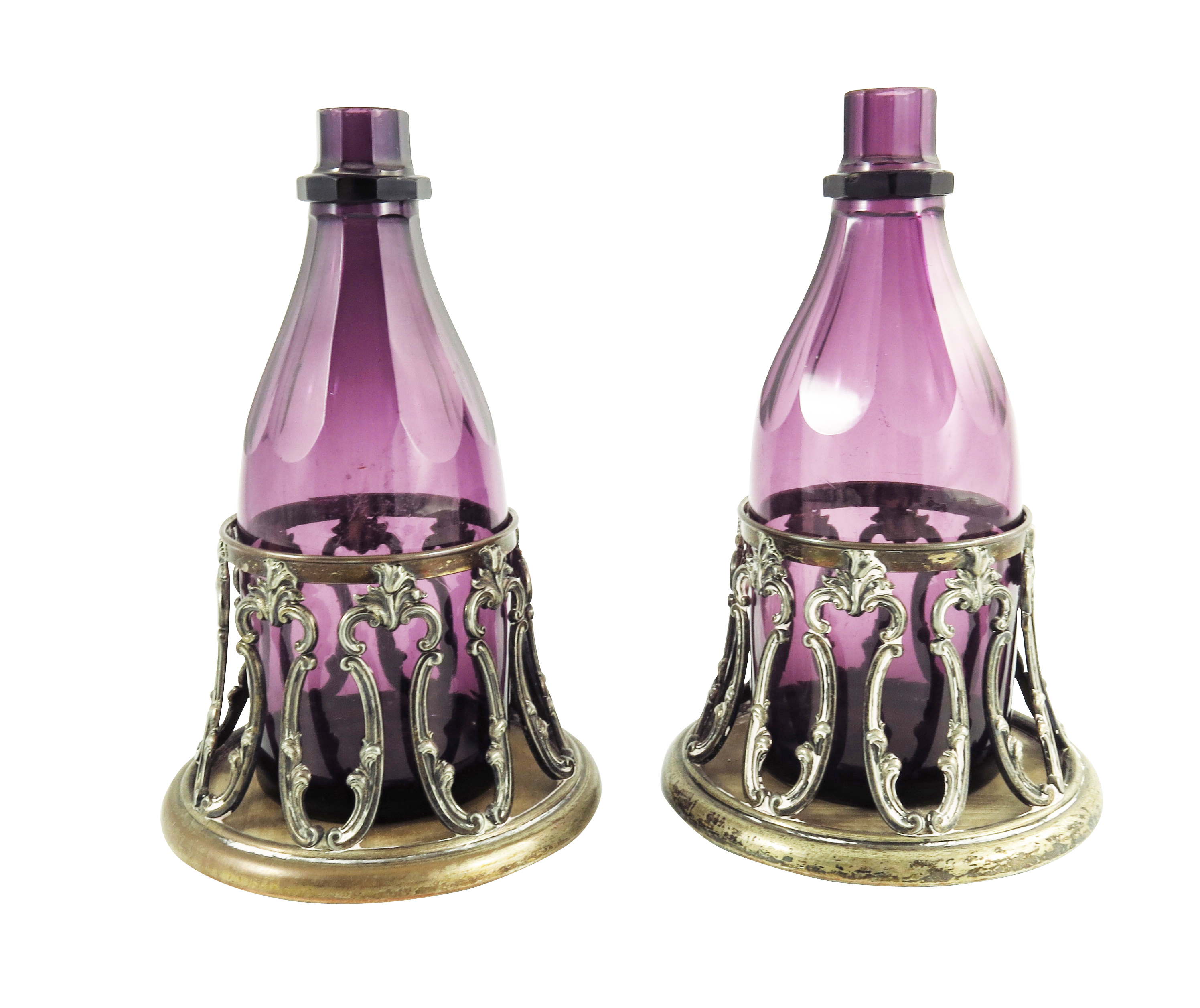 A pair of William IV amethyst glass decanters in original Old Sheffield Plate coasters