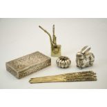 A group of eastern white metal items, including eight chopsticks, a container in the form of a rabbi