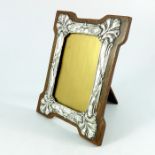 An Arts and Crafts silver and oak photo frame, W J Myatt and Co