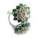A diamond and emerald cluster ring, on 18 carat white gold