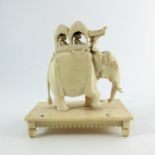 λ A 19th century Indian carved ivory figure of an elephant with Howdah