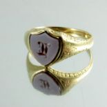 A childs cameo engraved gold signet ring