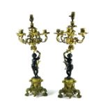 A pair of 19th century French bronze and ormolu figural candelabra