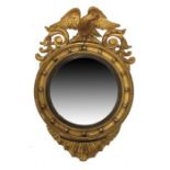 A George III Empire style gilt wood and gesso convex mirror