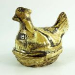 A Staffordshire agate ware money box, modelled as a hen