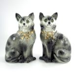 A pair of Staffordshire cat figures