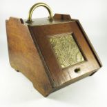 An Aesthetic Movement brass and oak coal scuttle