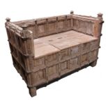 A 17th century panelled and iron strapped box settle