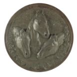 A cast bronze plaque of three horses at a trough, circular form, 45cm diameter