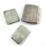 An Edwardian silver notebook and two George V silver cigarette cases