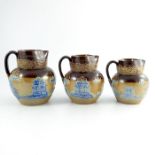 A graduated set of Royal Doulton relief applied Willow pattern stoneware jugs