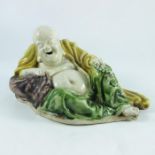 A Chinese polychrome glazed figure of a resting Buddha, 21cm long