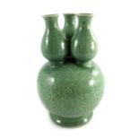 A Chinese celadon ground triple necked gourd vase,