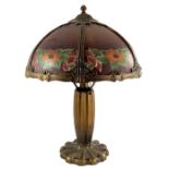 An American Art Nouveau gilt metal and painted glass table lamp