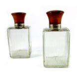 A pair of French Art Deco silver and tortoiseshell mounted cut glass bottles