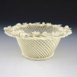 A Belleek basket, conical form with four strand rattan base
