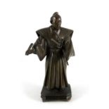 Bronze figure of a Samurai, robed and holding swords and fan.