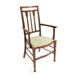 An Arts and Crafts mahogany and satinwood strung armchair