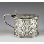 Charles Stuart Harris, London 1888, a Victorian silver mustard pot, cylindrical form, embossed with