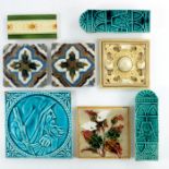 A collection of majolica glazed tiles and Aesthetic Movement door handles