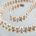 A single stand necklace of pink pearls