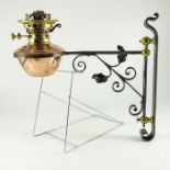A pair of Arts and Craft wrought iron, copper and brass wall mounted oil lights