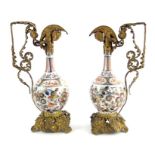 A pair of Japanese Imari bottle vases, gilt metal mouted into ewers