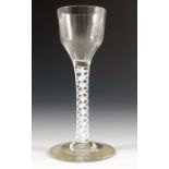 An 18th century opaque twist wine glass, circa 1760,