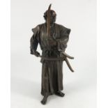A Japanese bronzed figure of a man holding swords,