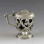 G E, London 1860, a Victorian silver vase- shaped mustard pot on a foliate cast and pierced domed fo