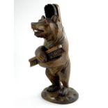 A Black Forest wooden carved bear brush holder