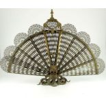 A 19th century cast brass and reticulated fan fire screen