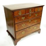 A George I walnut veneered chest of three short over three long graduated drawers