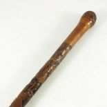 A Japanese carved bamboo cane