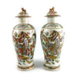 A pair of Chinese covered vases, shouldered form, butterflies to a white ground.