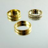 Two 22 carat gold wedding bands and another