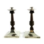 A E Jones, a pair of Arts and Cafts silver and rosewood candlesticks