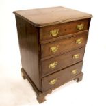 A George III style oak chest of four graduated drawers, of small proportions