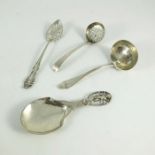 A collection of silver strainer spoons