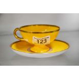 A Royal Worcester yellow ground cup and saucer