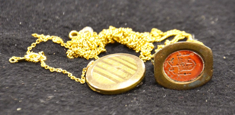 A yellow metal locket on a chain, together with a gilded seal on a yellow metal chain (2)