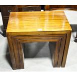 A nest of three rosewood occasional tables, height 51cm