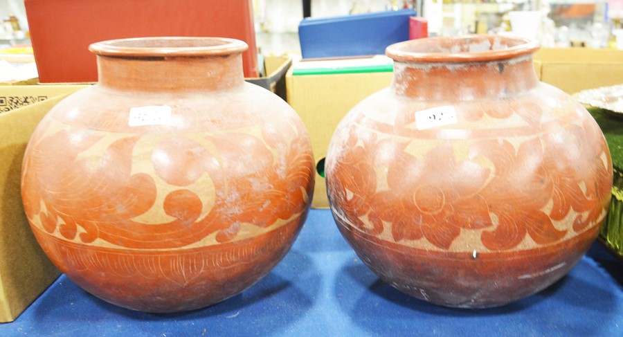 Two large middle eastern pots with foliate decorat