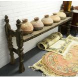 A Caucasus region primitive tribal wooden stand fitted five terracotta jars