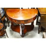 A Mahogany demi lune hall table with acanthus carved support on ogee form base.80cm wide