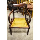 A mahogany chair with scroll armrests and a rattan seat, 79cm high