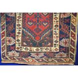 A Persian style knotted woollen rug, 121cm x 195cm