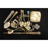 A mixture of white metal objects including a cigarette case, fobs, chains and spoons